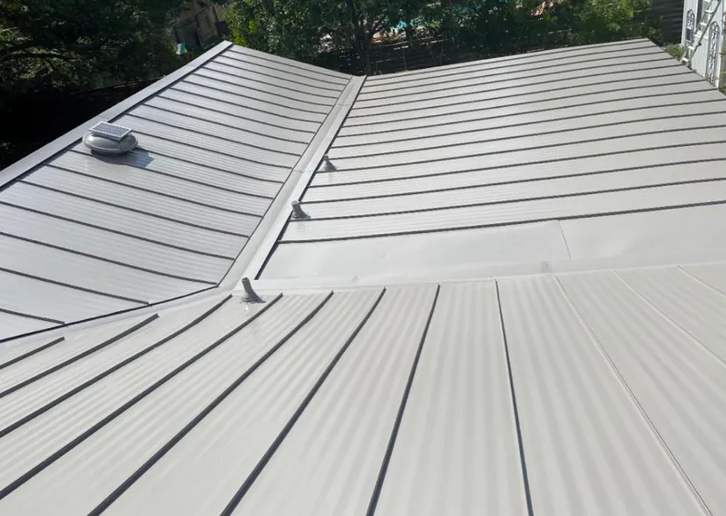 Solar attic fan installed on a metal roof for Roof Ventilation in Salina